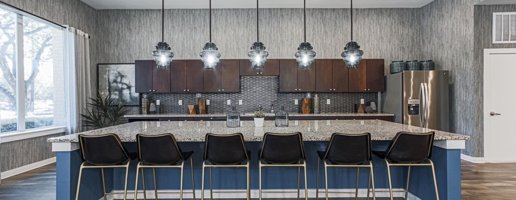 a kitchen with a bar and chairs