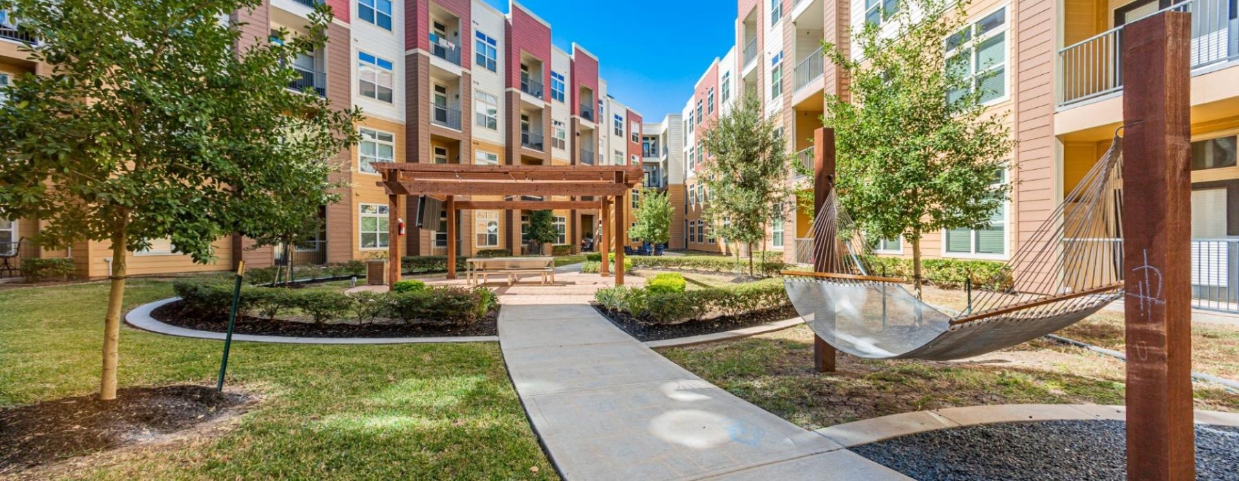 a courtyard with a fountain and buildings